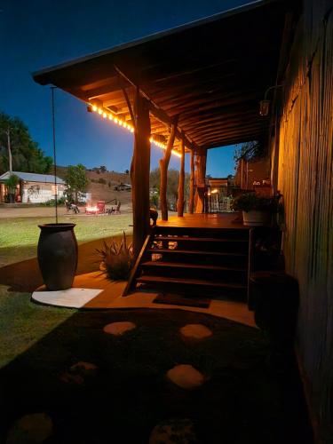 a pergola with a bench in a yard at night at Barn on the Burnett, Mundubbera in Mundubbera