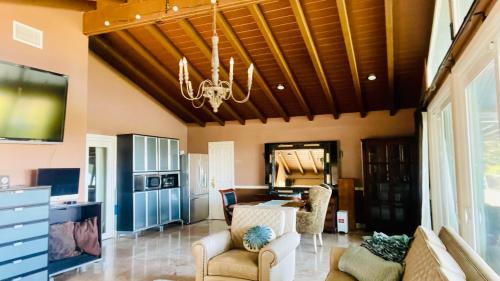 a living room with a couch and a chandelier at Private Studio Style & Bedroom View Pool Big Estate Oasis Extra Fee 4 Guest Clea-ning Pet WOMEN ONLY in Los Angeles