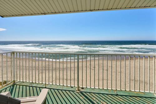 a view of the beach from a balcony at Oceanfront Family Suite With Full Kitchen Beach Access Pool & Hot Tub in Lincoln City