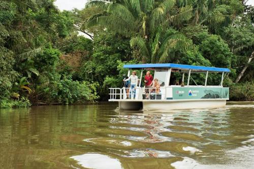 a group of people on a boat on a river at Mirador House, Cozy Private Home W- Volcano View in El Castillo de la Fortuna