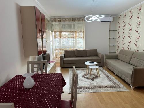 a living room with a couch and a table at Diora's Apartment in Durrës