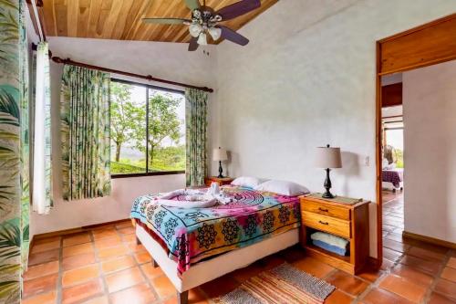 a bedroom with a bed and a window at Serenity House Panoramic Views And Swimming Pool, in El Castillo de la Fortuna