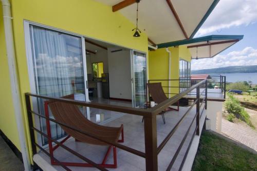 a balcony of a house with a table and chairs at New, Hilltop Bungalow 1 W- Spectacular Volcano View in El Fosforo