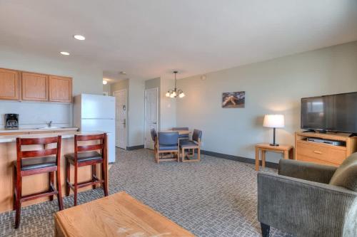 a kitchen and a living room with a couch and a table at Oceanfront Suite - 2 Queen Beds - Beach Access - Pool and Hot Tub in Lincoln City