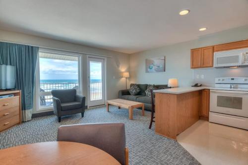 a kitchen and living room with a view of the ocean at Oceanfront Suite - 2 Queen Beds - Beach Access - Pool and Hot Tub in Lincoln City
