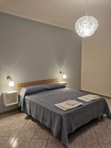 a bedroom with a bed with two towels on it at Villa Paradise in Capo Vaticano
