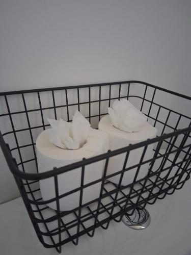 a wire basket with towels on top of it at Crown House Studio Apartment in Birmingham