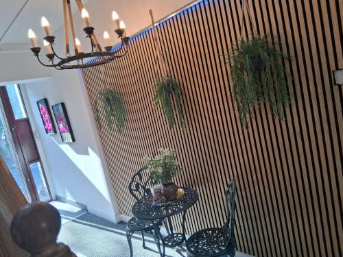 a room with a table with plants on a wall at Crown House Studio Apartment in Birmingham