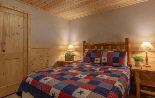 a bedroom with a bed and two night stands at Summer Adventure Awaits! Hidden Pines- Yellowstone in Island Park