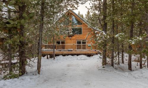 a log cabin in the woods in the snow at Summer Adventure Awaits! Hidden Pines- Yellowstone in Island Park
