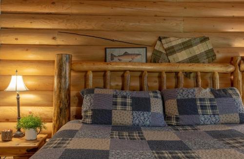 a bedroom with a bed in a log cabin at Summer Adventure Awaits! Hidden Pines- Yellowstone in Island Park