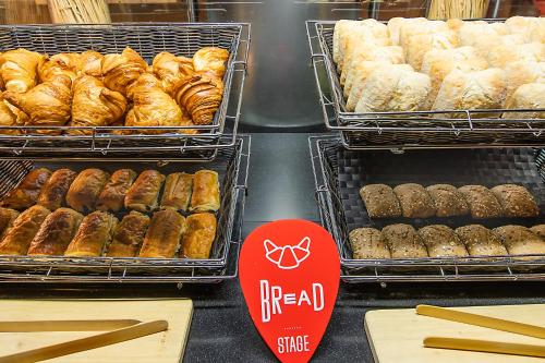 a bakery with trays of different types of donuts at Hotel ibis Lisboa Liberdade in Lisbon