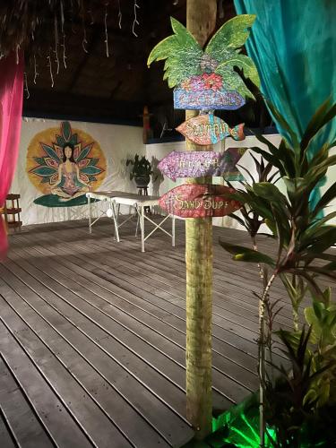 a pole withanas on it on a wooden deck at POUSADA Coisa Mais Linda e Massagem in Cascavel