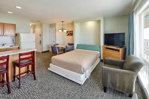 a bedroom with a bed and a kitchen with a table at Oceanfront Family Suite - Full Kitchen - Easy Beach Access in Lincoln City