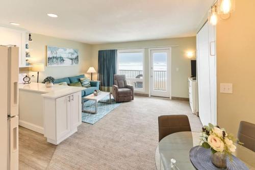 a living room with a couch and a table at Stunning Oceanfront Suite - Full Kitchen - Pool and Hot Tub in Lincoln City