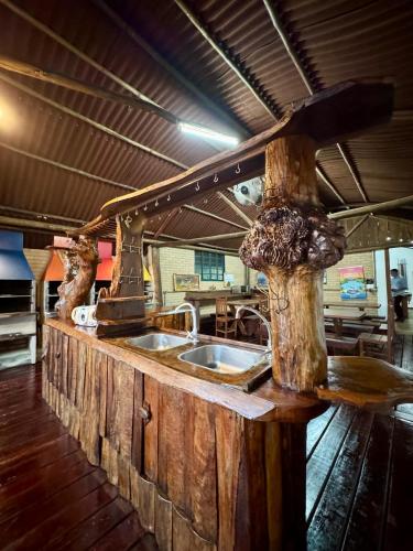 a kitchen with a counter with two sinks in it at SR Dom Quixote in São Pedro