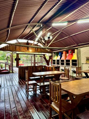 a restaurant with wooden tables and benches in a room at SR Dom Quixote in São Pedro