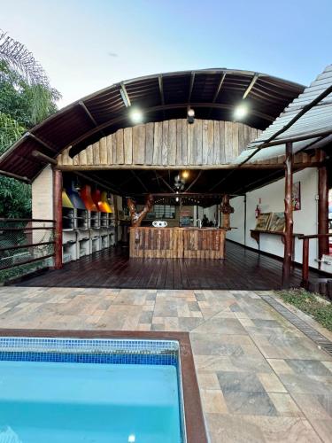 a patio with a swimming pool and a wooden deck at SR Dom Quixote in São Pedro