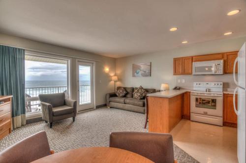 a kitchen and living room with a couch and a table at Beachfront Family Suite - Ocean View - Full Kitchen in Lincoln City