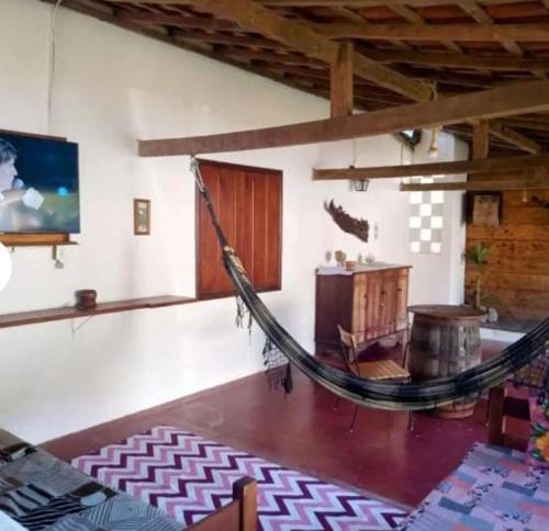 a room with a hammock in the middle of a room at Casa Soul Green in Paraty