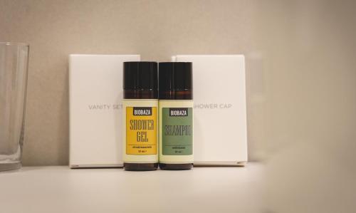 a group of four bottles of essential oils on a counter at Vogel Rooms Tvrđa Osijek in Osijek