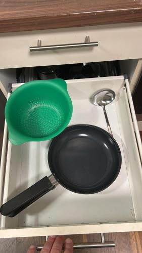 a frying pan and spatula on top of a stove at 80 m2 Rooftop Apartment with Balcony & Free Parking in Gerasdorf bei Wien