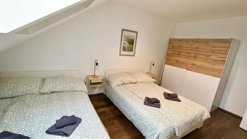 a bedroom with two beds with hats on them at 80 m2 Rooftop Apartment with Balcony & Free Parking in Gerasdorf bei Wien