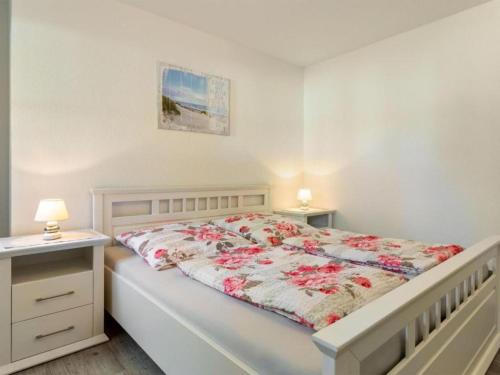 a bedroom with a bed and two night stands and two lamps at Friederike in Tarnewitz