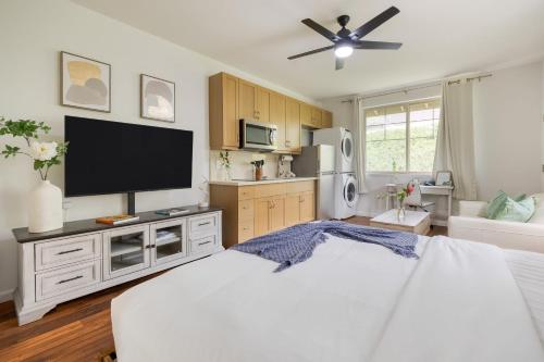 a bedroom with a large bed with a flat screen tv at Studio Nene by AvantStay Chic Cozy King Bed in Waianae