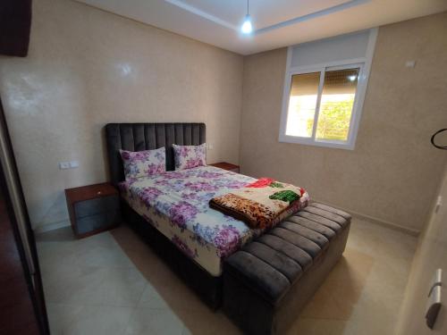 a small bedroom with a bed and a window at Relaxing home in Id Taleb