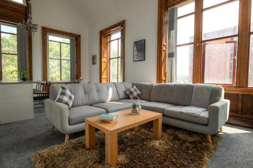 a living room with a couch and a coffee table at Double story Suite in Rochdale in Rochdale