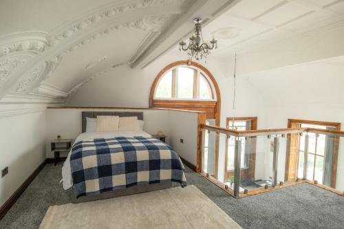 a bedroom with a bed and a large window at Double story Suite in Rochdale in Rochdale