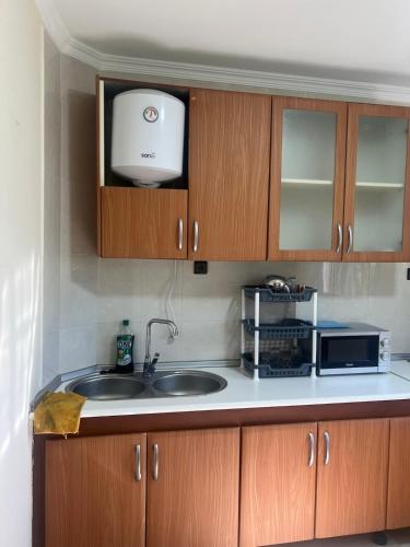 a kitchen with a sink and a microwave at PARADISE APARTment #2 in Idoudouhane