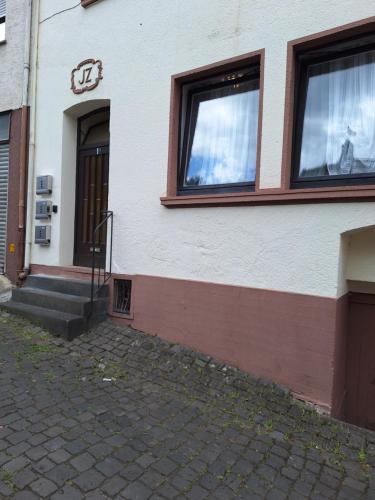 a building with two windows and a staircase outside at Apartment B&J Cochem in Cochem