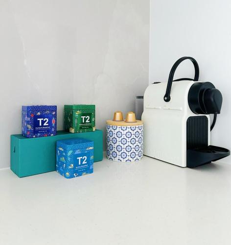 a white toaster sitting on a shelf next to boxes at BLANC Suites Unit9 in Silverdale
