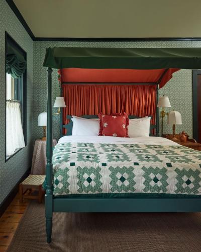 a bedroom with a large bed with a green canopy at Six Bells Countryside Inn in Rosendale