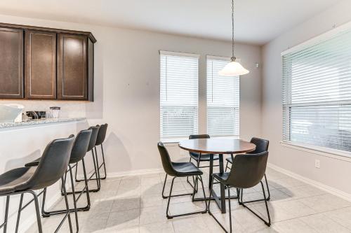 a kitchen and dining room with a table and chairs at Grand Family Home with Patio and Fenced Yard in Arcola 
