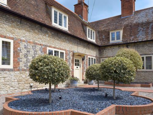 two trees in front of a brick building at Dulcie Cottage in Benson