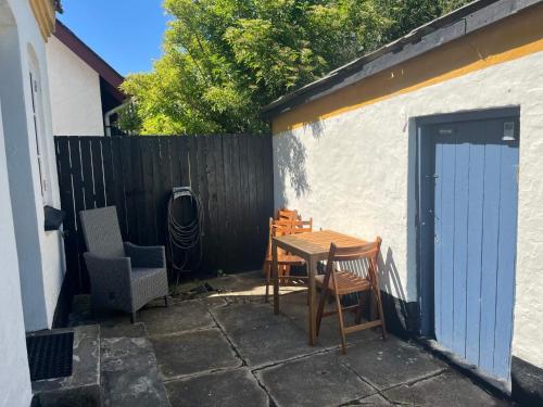 a patio with a table and chairs and a fence at 6 person holiday home in Løkken in Løkken
