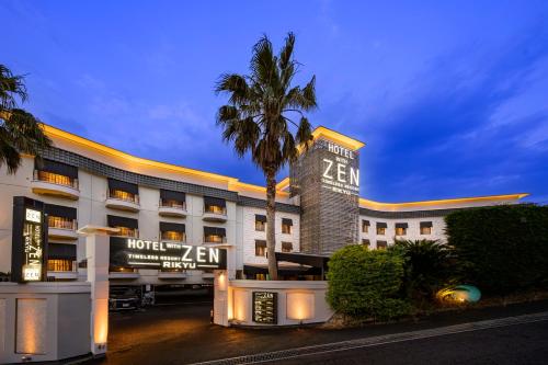 a hotel with a palm tree in front of a building at Hotel Zen Rikyu Yokohama Hazawa in Yokohama