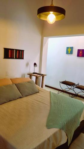 a bedroom with a large bed with a large window at Posada El Prado in Salta