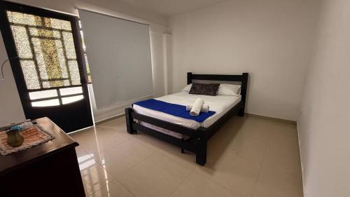 a bedroom with a bed in a room with a window at Quinta de San Pedro in Villavicencio