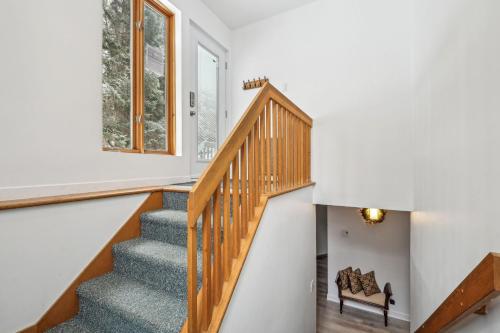 a staircase in a home with white walls at Big Sunshine in Mont-Tremblant