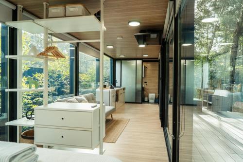 a bathroom with a white vanity and a large window at Coastal Bliss New Brighton Eco Pod 50m to Beach in New Brighton