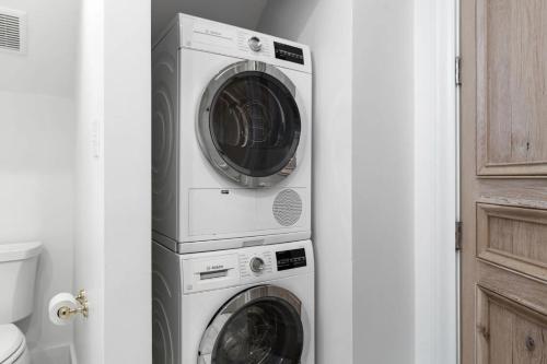 two washing machines and a washer and dryer in a bathroom at Rosemary Bluegrass in Rosemary Beach