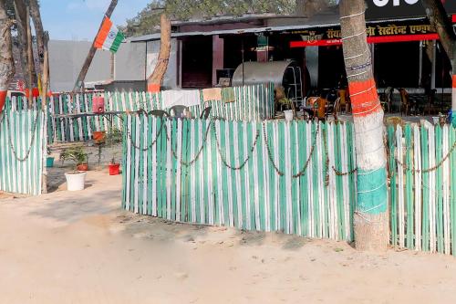 a fence in front of a building with at Hotel O Shyam Hotel in Sitāpur