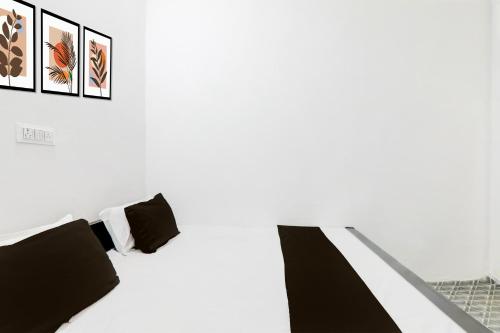 a bedroom with black and white furniture and pictures on the wall at Hotel O Shyam Hotel in Sitāpur