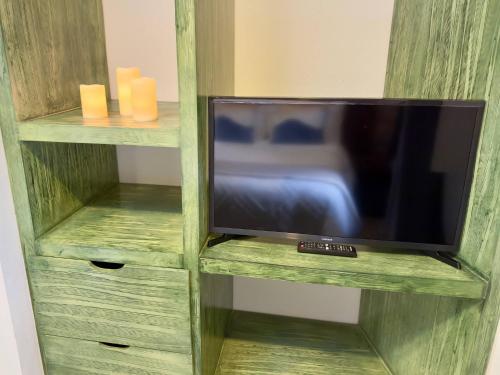 a tv in a wooden book shelf with a tv at Apolonia en ValQuirico in Santeagueda