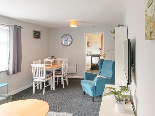 a kitchen and dining room with a table and chairs at Seashell Cove in Cemaes Bay