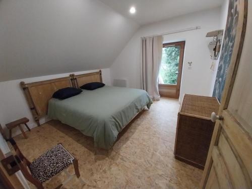 a bedroom with a bed and a large window at Gîte familial à Chavroches, animaux acceptés - FR-1-489-574 in Chavroches